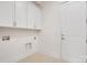 Clean laundry room with overhead cabinets and tile flooring at 6712 Cove Ln, Sherrills Ford, NC 28673