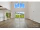 Bright living room featuring hardwood floors, large windows, and access to outdoor living space at 6712 Cove Ln, Sherrills Ford, NC 28673