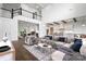 Open-concept living room with a grand staircase, hardwood floors, and seamless flow to the dining and kitchen areas at 6712 Cove Ln, Sherrills Ford, NC 28673