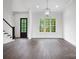 Spacious living area with hardwood floors, staircase, large windows, and modern light fixture at 6712 Cove Ln, Sherrills Ford, NC 28673