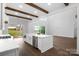 Bright, open-concept living room with high ceilings, exposed wood beams, island, and hardwood floors at 6712 Cove Ln, Sherrills Ford, NC 28673
