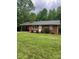 Charming one-story brick home featuring a carport, manicured lawn, and mature trees at 755 Victory Grove Church Rd, Lincolnton, NC 28092