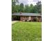 Charming one-story brick home featuring a carport, manicured lawn, and mature trees at 755 Victory Grove Church Rd, Lincolnton, NC 28092