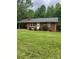 Charming one-story brick home featuring a carport, manicured lawn, and mature trees at 755 Victory Grove Church Rd, Lincolnton, NC 28092