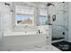 Modern bathroom with marble-style walls, freestanding tub, glass-enclosed shower, and black accents at 8004 Fountainbrook Dr # 15, Indian Trail, NC 28079