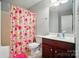 Bathroom with a floral shower curtain, single sink vanity, and tiled floor at 8004 Fountainbrook Dr # 15, Indian Trail, NC 28079