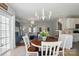 Open dining area with chandelier, connecting the kitchen and living room at 8004 Fountainbrook Dr # 15, Indian Trail, NC 28079