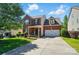 Charming two-story brick home with a well-manicured lawn and a two-car garage on a sunny day at 8004 Fountainbrook Dr # 15, Indian Trail, NC 28079