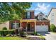 Charming two-story brick home with black shutters and a well-manicured lawn at 8004 Fountainbrook Dr # 15, Indian Trail, NC 28079