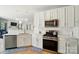 Well-lit kitchen with stainless steel microwave and oven, with white tile backsplash at 8004 Fountainbrook Dr # 15, Indian Trail, NC 28079