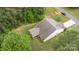 Aerial view of the back of the home shows the back porch, pristine landscaping and mature trees at 8112 Mossy Rock Rd, Waxhaw, NC 28173