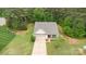 Overhead view of a charming home with long driveway, lush lawn, mature trees and landscaping at 8112 Mossy Rock Rd, Waxhaw, NC 28173