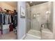 Bathroom with walk-in closet, glass shower, and gray tile at 8112 Mossy Rock Rd, Waxhaw, NC 28173