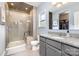 Bathroom featuring gray cabinetry, glass shower, and tile flooring at 8112 Mossy Rock Rd, Waxhaw, NC 28173