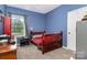Bedroom featuring neutral carpet, window, and closet at 8112 Mossy Rock Rd, Waxhaw, NC 28173