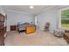 Spacious bedroom with a ceiling fan, carpeted floors, and natural light at 8112 Mossy Rock Rd, Waxhaw, NC 28173