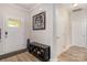 Welcoming foyer with updated flooring, shoe bench and convenient coat closet at 8112 Mossy Rock Rd, Waxhaw, NC 28173