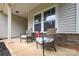 Cozy front porch features wicker seating and charming decor, perfect for relaxing outdoors at 8112 Mossy Rock Rd, Waxhaw, NC 28173