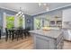 Open kitchen with granite countertops, stainless steel appliances, and hardwood floors adjacent to dining area at 8112 Mossy Rock Rd, Waxhaw, NC 28173