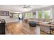 Bright living room with hardwood floors, modern furniture, ceiling fan and view of the dining room at 8112 Mossy Rock Rd, Waxhaw, NC 28173