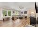 Spacious living room features natural light, neutral tones, wood-look floors and modern ceiling fan at 8112 Mossy Rock Rd, Waxhaw, NC 28173