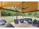 Relaxing covered patio perfect for outdoor seating with ceiling fan and wooded view at 8112 Mossy Rock Rd, Waxhaw, NC 28173