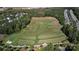 Aerial view featuring the neighborhood practice golf course and driving range, with houses in the distance at 9802 Sky Vista Dr, Huntersville, NC 28078