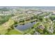 Picturesque aerial shot of a neighborhood with a serene pond surrounded by trees and well-maintained homes at 9802 Sky Vista Dr, Huntersville, NC 28078