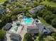 Aerial view of the pool and amenity center with mature trees and neighborhood in the background at 9802 Sky Vista Dr, Huntersville, NC 28078