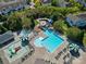Aerial shot of the pool area showcasing multiple pools and splashpad with playground and mature trees at 9802 Sky Vista Dr, Huntersville, NC 28078