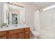Bright bathroom with modern sink, mirror and vanity, shower-tub combination and a window for natural light at 9802 Sky Vista Dr, Huntersville, NC 28078