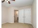 Spacious bedroom featuring neutral walls, beige carpet, a ceiling fan, and an ensuite entry at 9802 Sky Vista Dr, Huntersville, NC 28078