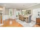 Hardwood floored dining room with elegant chandelier, wainscoting, and view of the backyard at 9802 Sky Vista Dr, Huntersville, NC 28078