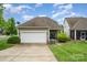 Charming home with a two-car garage, well-manicured lawn, and inviting curb appeal at 9802 Sky Vista Dr, Huntersville, NC 28078