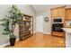 Open kitchen area with wooden cabinets and flooring, alongside a shelving unit and plant at 9802 Sky Vista Dr, Huntersville, NC 28078