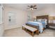 Comfortable bedroom with a large bed, bench and side tables with carpet floors at 9802 Sky Vista Dr, Huntersville, NC 28078