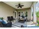 Covered patio with comfortable seating and ceiling fan, perfect for outdoor relaxation and entertaining at 9802 Sky Vista Dr, Huntersville, NC 28078