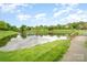 Scenic view of the community pond with a walking path and bridge at 9802 Sky Vista Dr, Huntersville, NC 28078