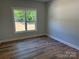 Bright bedroom features hardwood floors and a large window with outdoor views at Lot 9 Lilly Pad Dr, Salisbury, NC 28146