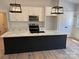 Kitchen island with a white countertop and black base providing ample counter space and storage at Lot 9 Lilly Pad Dr, Salisbury, NC 28146