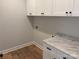 Laundry room featuring white cabinets with black hardware and marble countertop at Lot 9 Lilly Pad Dr, Salisbury, NC 28146