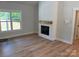 Living room features a fireplace with wood mantle and a large window overlooking the lawn at Lot 9 Lilly Pad Dr, Salisbury, NC 28146