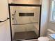 Walk-in shower with marble-look tile, black trim and hardware, a built-in shelf, and bench at Lot 9 Lilly Pad Dr, Salisbury, NC 28146