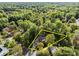 Aerial shot of a secluded house surrounded by mature trees and professionally maintained landscape at 10009 Lattice Ct, Charlotte, NC 28269