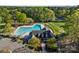 Aerial view of the community pool and clubhouse, nestled among lush trees at 10009 Lattice Ct, Charlotte, NC 28269