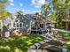 Expansive backyard showcasing the home's exterior, a well-manicured lawn, and outdoor entertaining space at 10009 Lattice Ct, Charlotte, NC 28269
