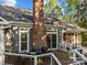 Backyard deck features patio seating and a brick chimney, ideal for outdoor enjoyment at 10009 Lattice Ct, Charlotte, NC 28269
