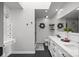 Bright bathroom features double vanity, skylight, decorative wreaths and modern fixtures at 10009 Lattice Ct, Charlotte, NC 28269