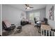 Bedroom with comfortable seating area, ceiling fan, and soft, neutral color scheme at 10009 Lattice Ct, Charlotte, NC 28269