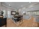 Stylish dining room with a dark wood table, neutral walls, and hardwood flooring at 10009 Lattice Ct, Charlotte, NC 28269
